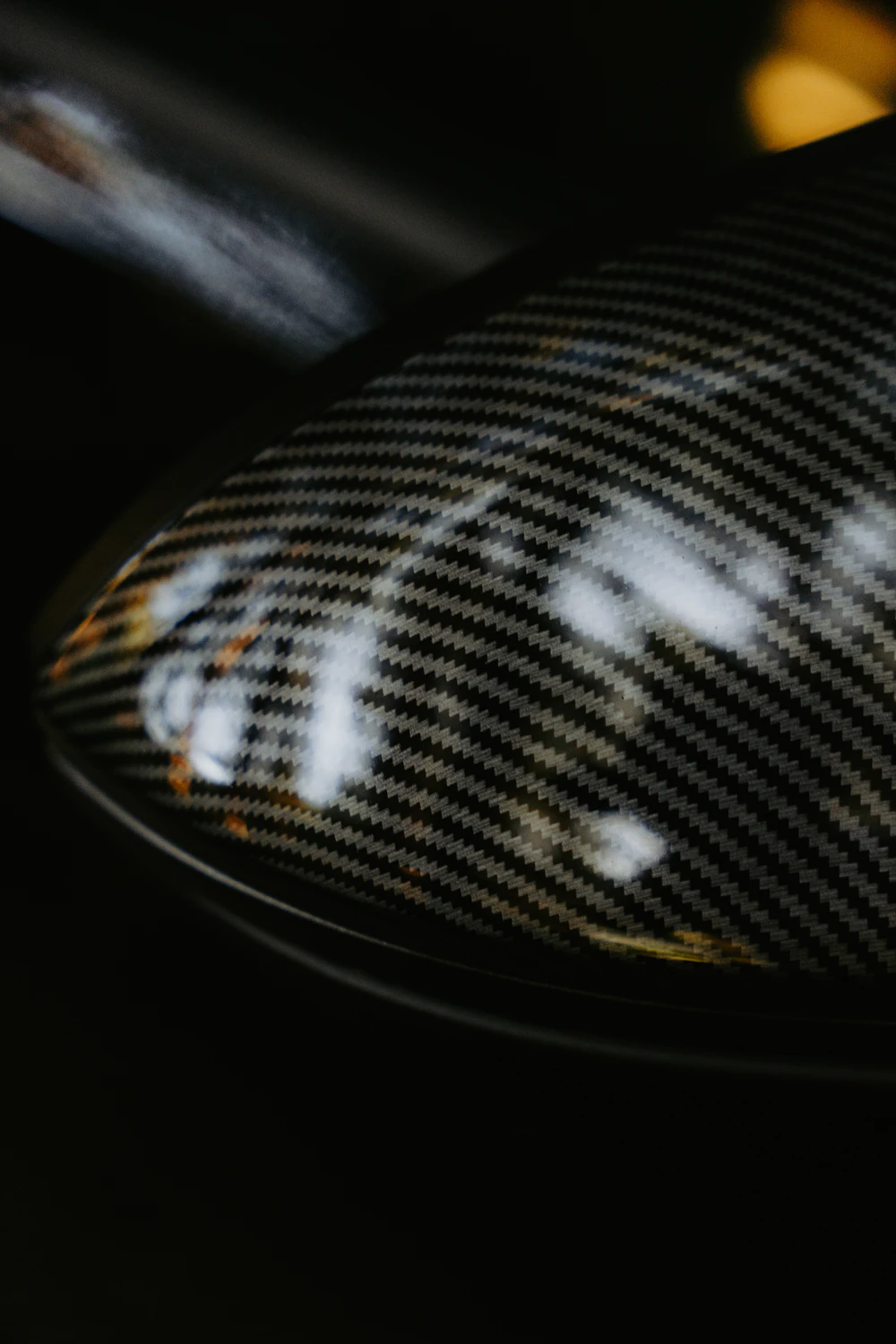 Genuine woven carbon fibre texture on a car mirror