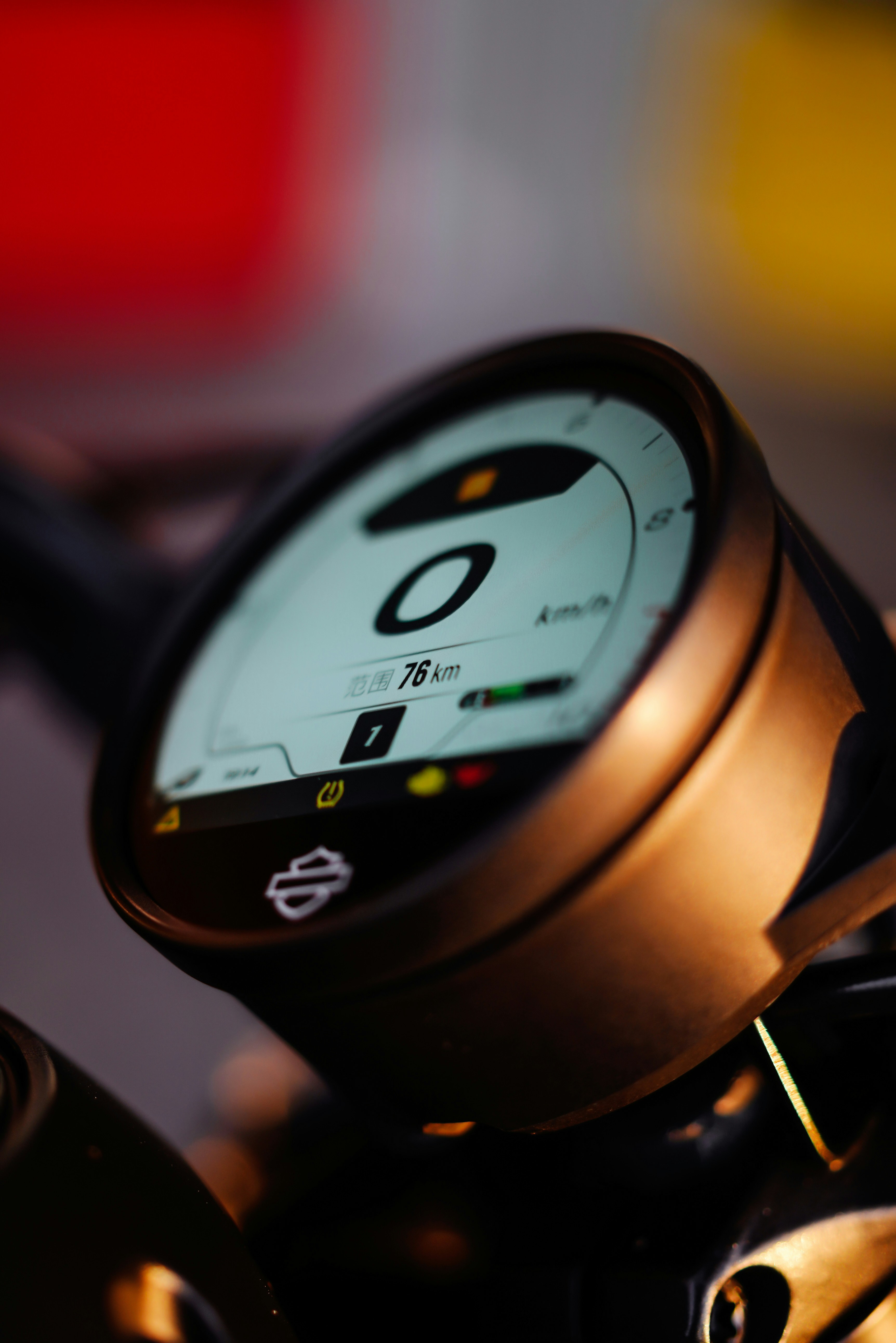 Motorcycle speedometer showing zero kilometers per hour.