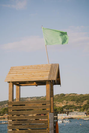 Green flag flies over a lifeguard station.