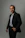 A man in a suit poses for a portrait