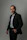 A man in a suit poses for a portrait
