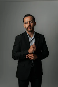 Man in a suit looks at the camera.