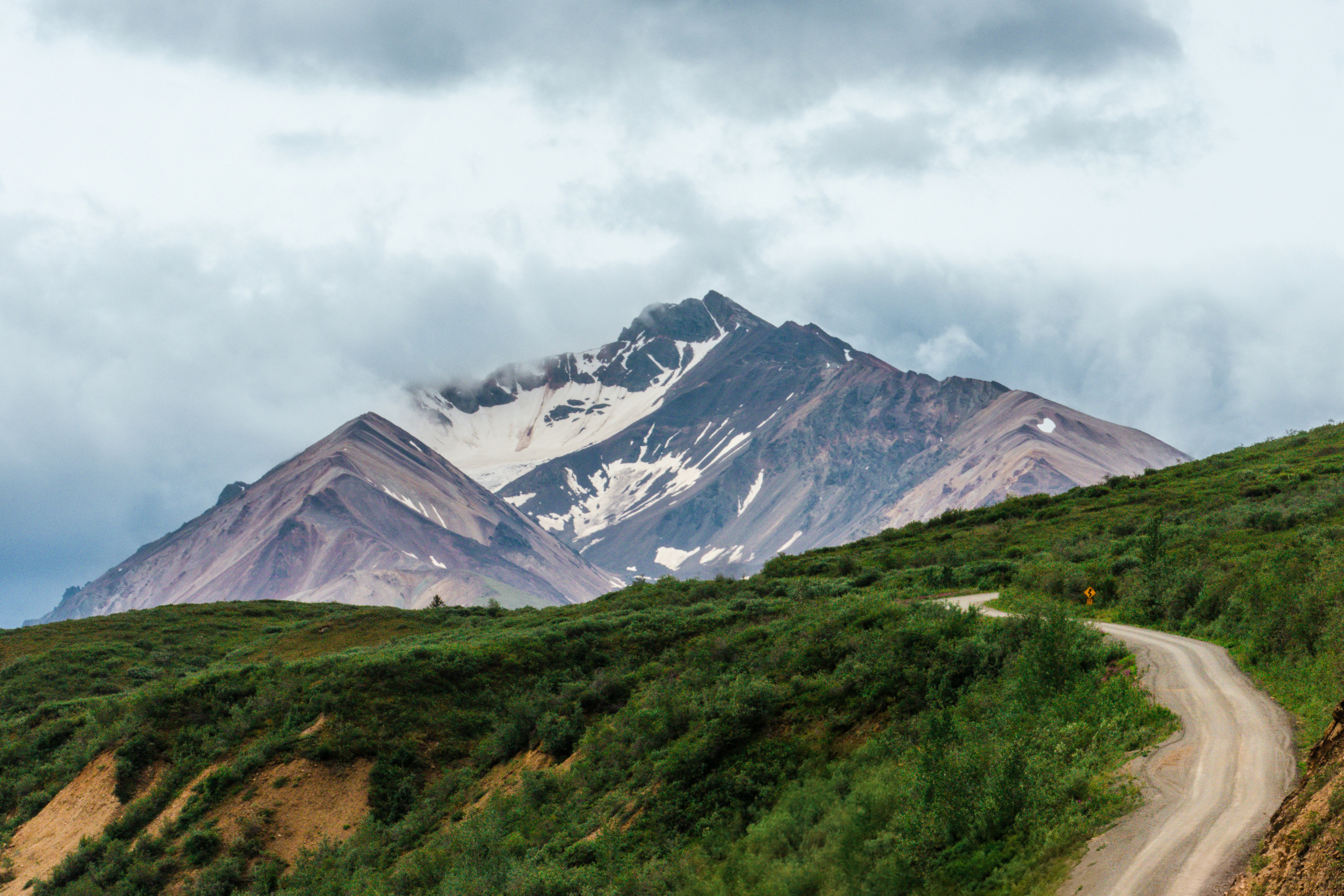A winding road leads to a mountain.