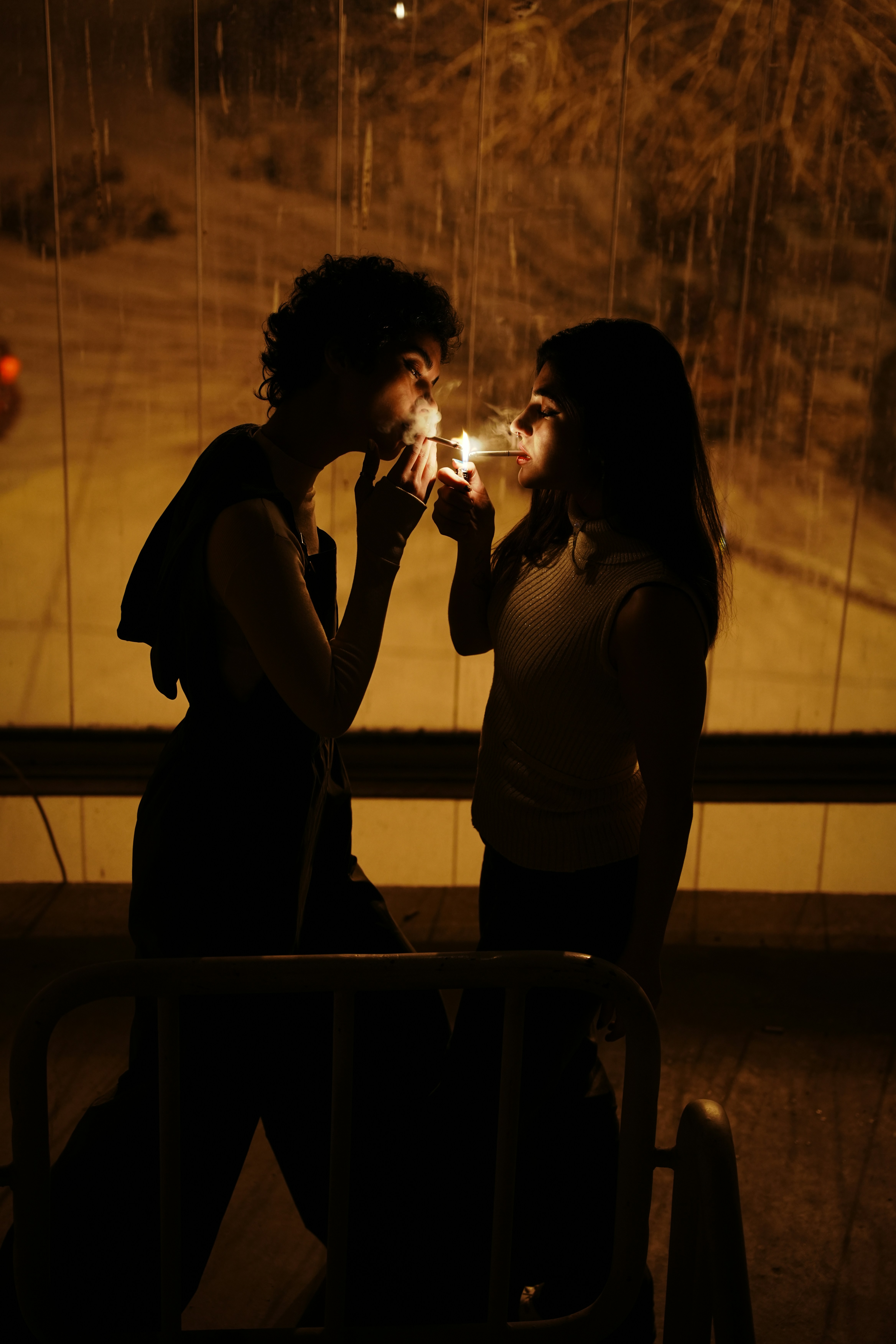 Two people light cigarettes in the dark. photo – Free Woman Image on  Unsplash