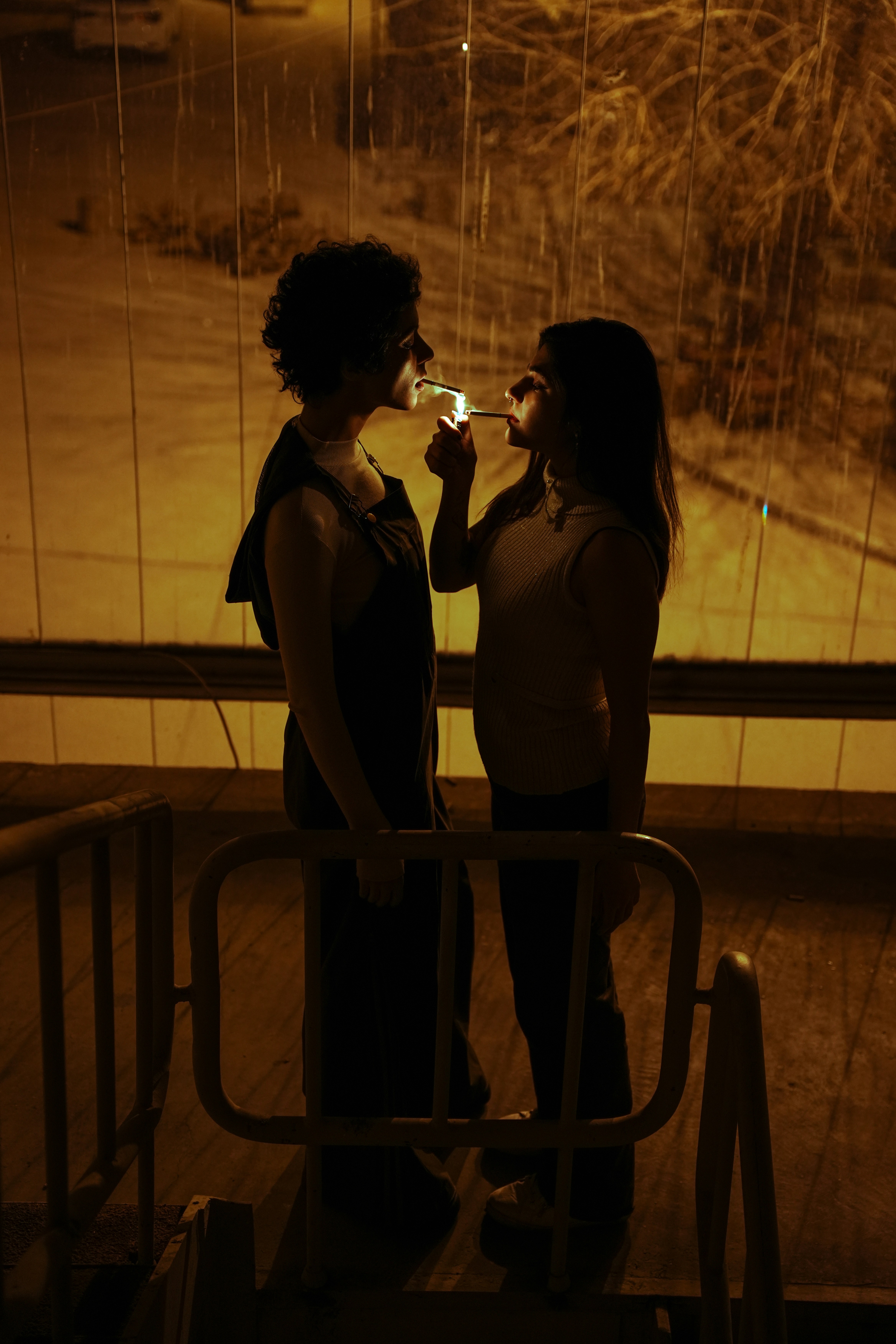 couple lighting cigarette Two people share a cigarette in the night. photo – Free Woman Image on  Unsplash