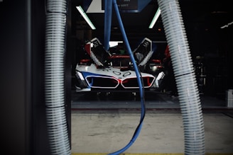 Race car getting serviced in the garage.