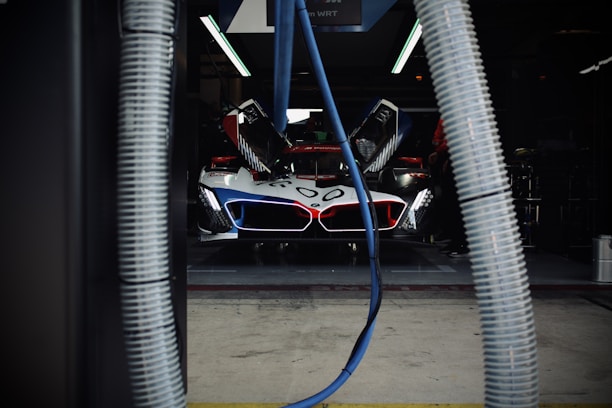 Race car getting serviced in the garage.