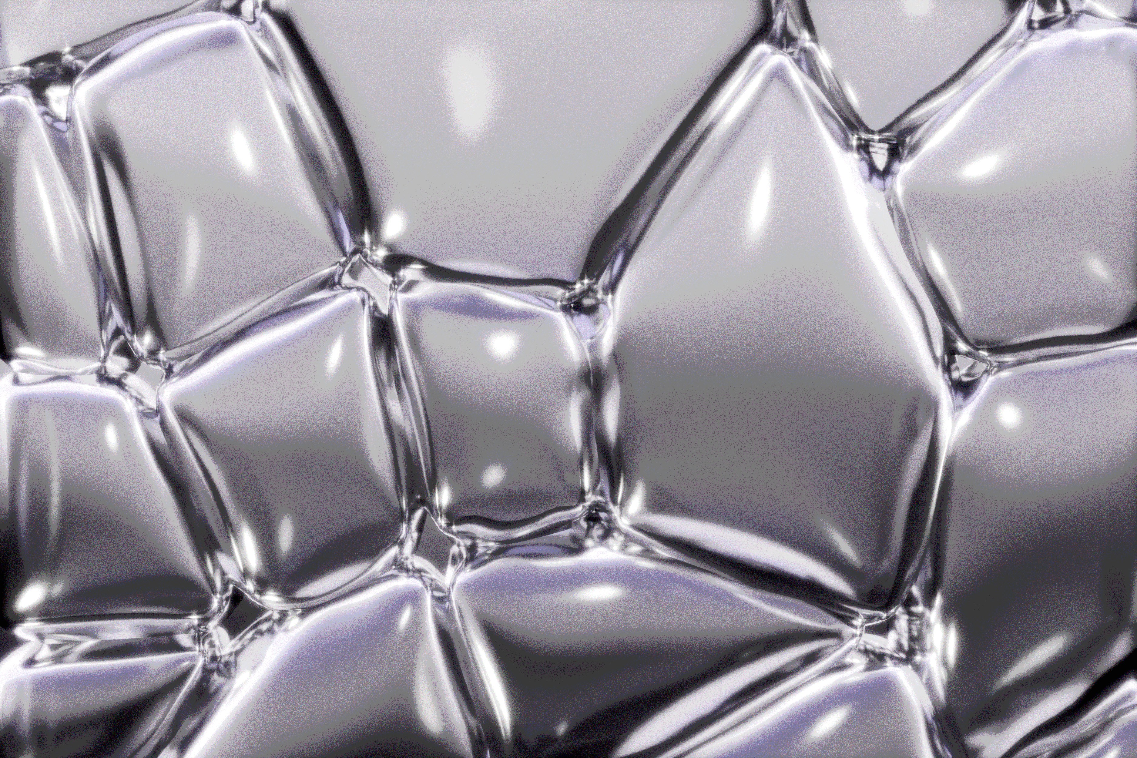 Shiny, metallic shapes form a bubbly texture.