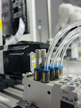 Close-up of industrial pneumatic system with tubes.
