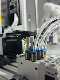 Close-up of industrial pneumatic system with tubes.