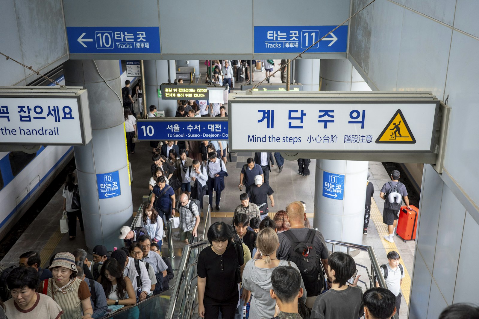People walk through a subway entrance in south korea.