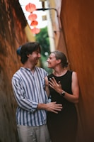 Couple shares a loving moment in a narrow alley.