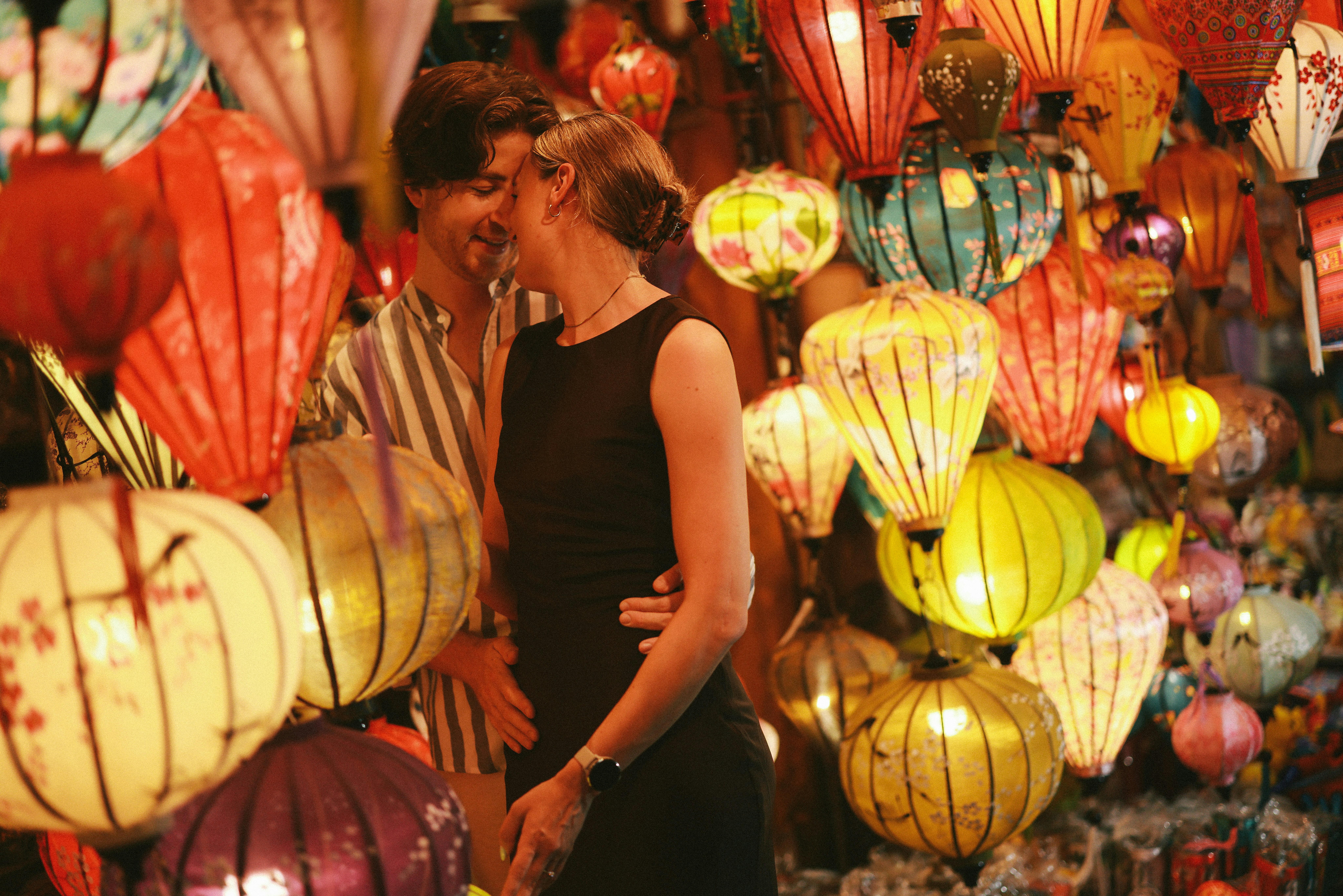 Couple sharing tender moment with lanterns