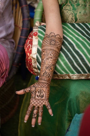 An arm is adorned with henna artwork.