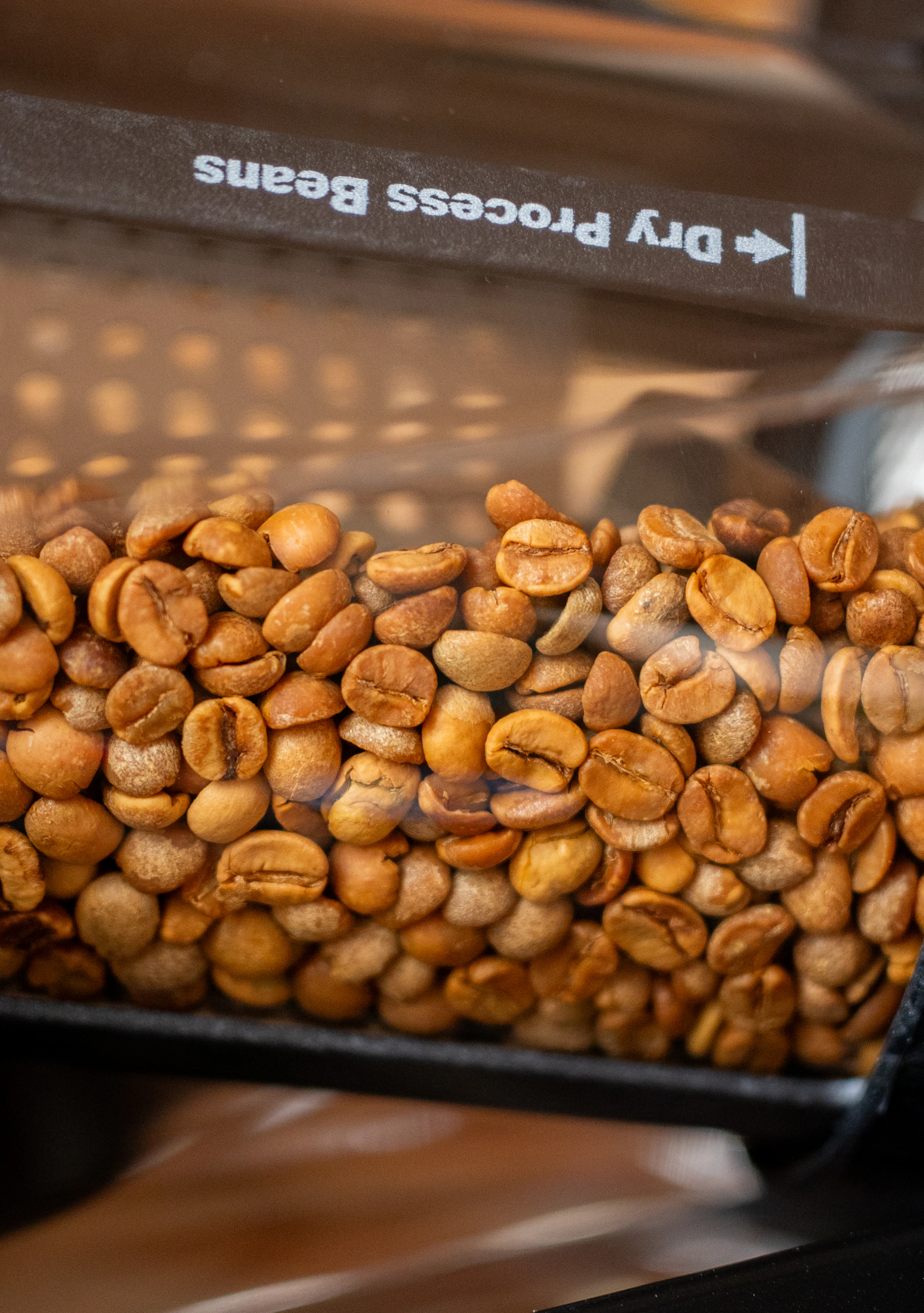 Here's a caption for the image: dry process coffee beans are stored.