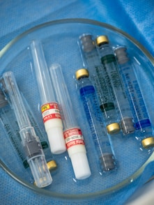 Syringes and vials rest in a medical tray.