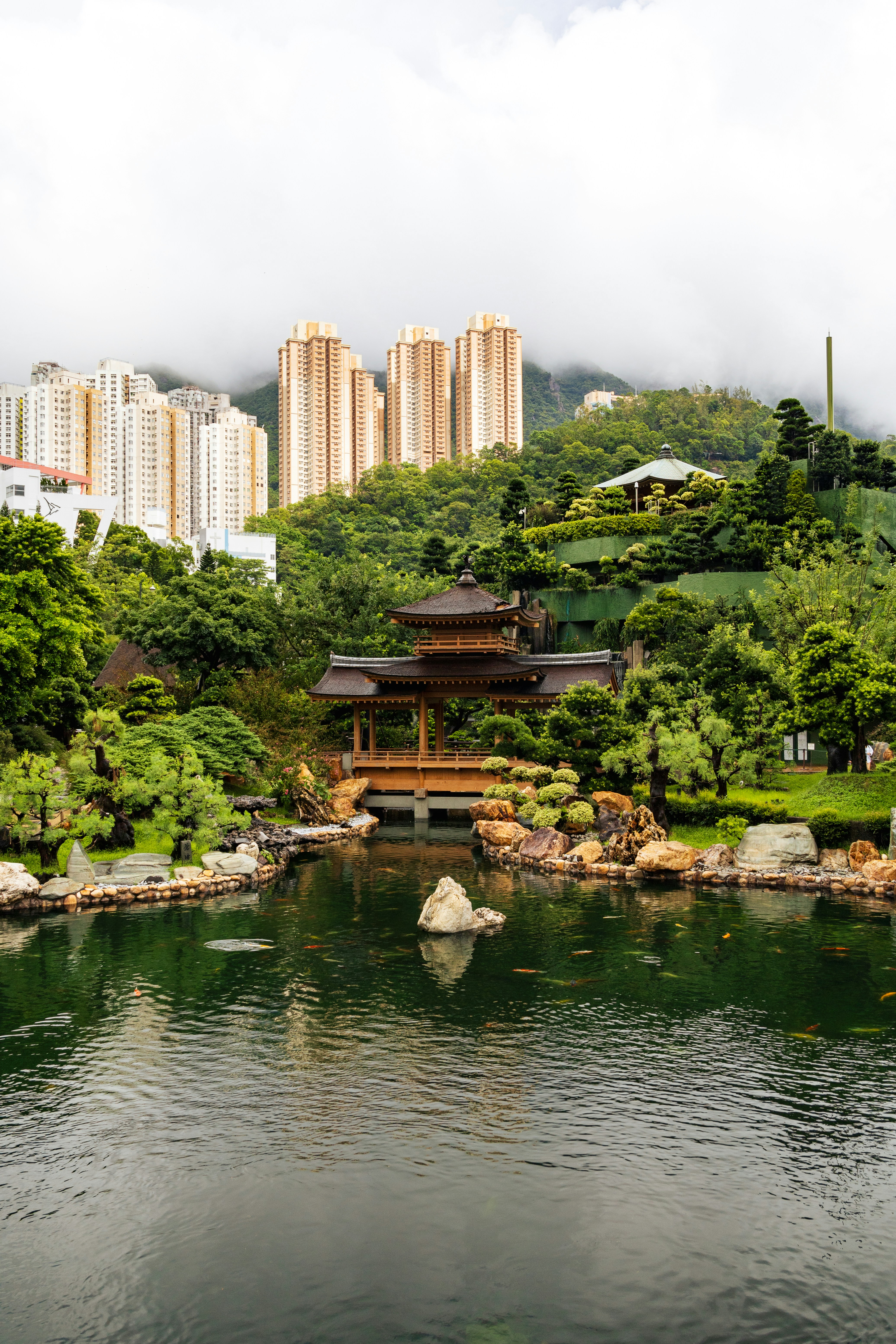 A beautiful chinese pagoda by a calm pond.