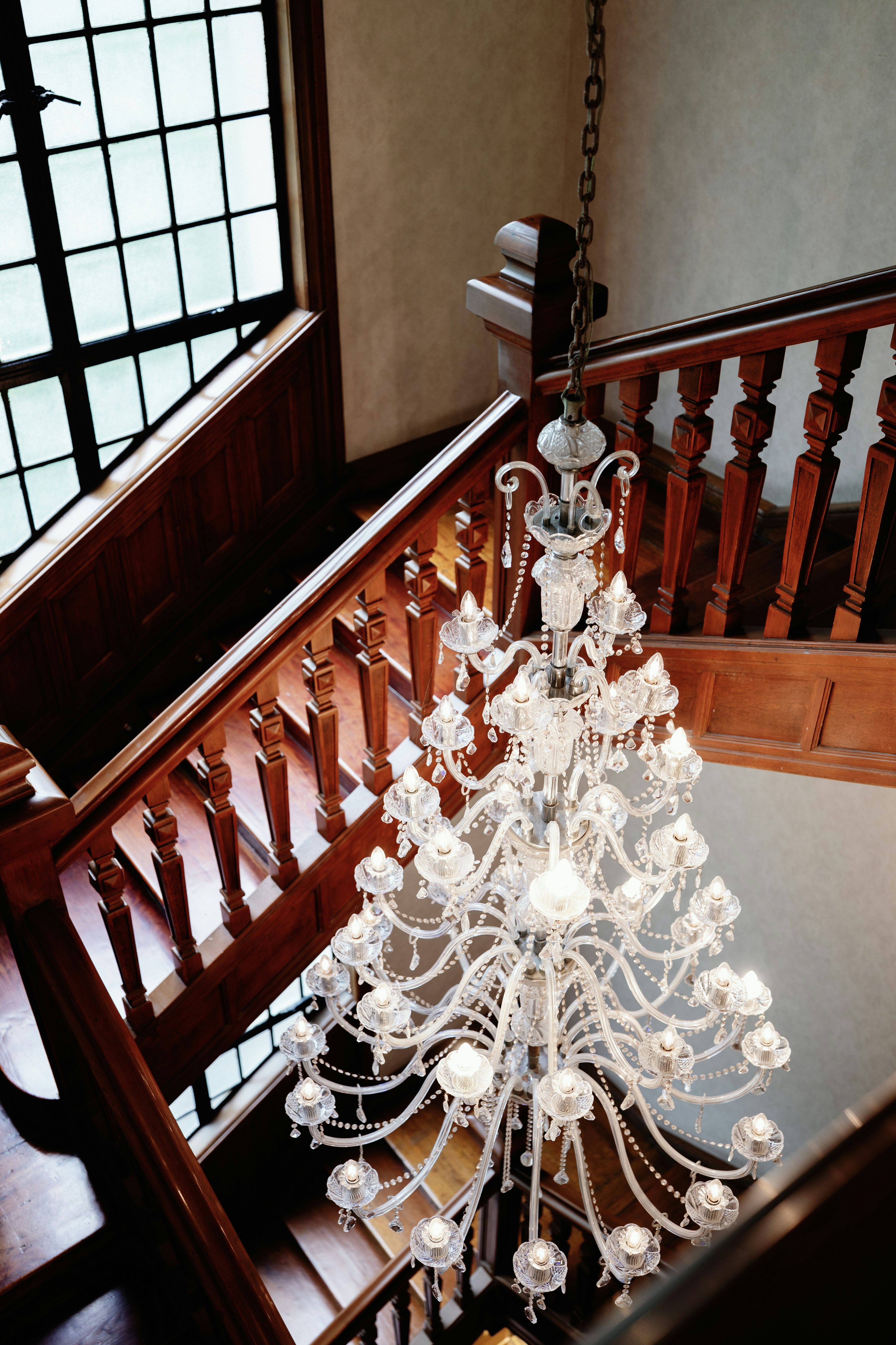 Crystal chandelier above a wooden staircase in a heritage Sydney home