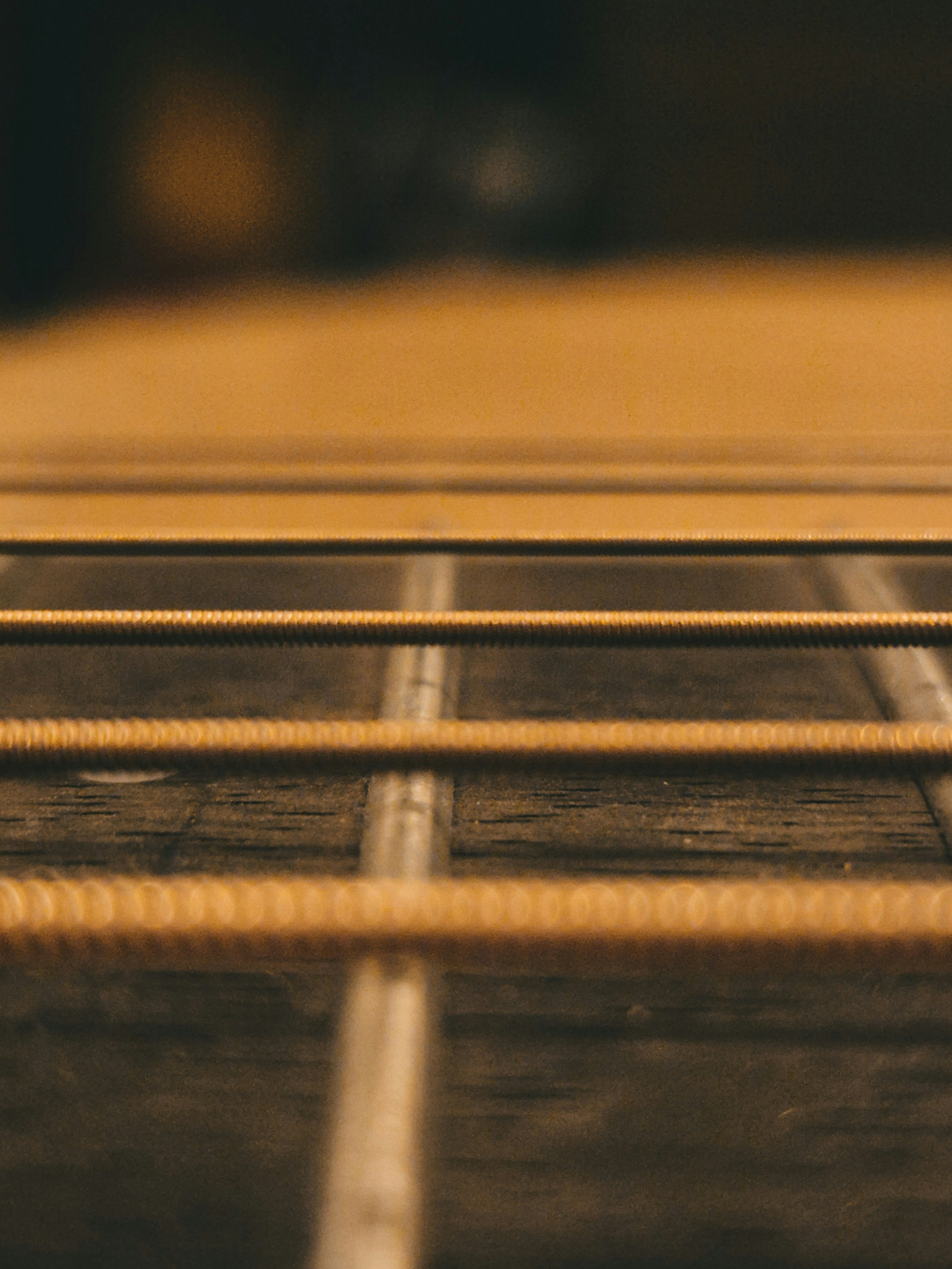 A close-up shot of a guitar's strings.