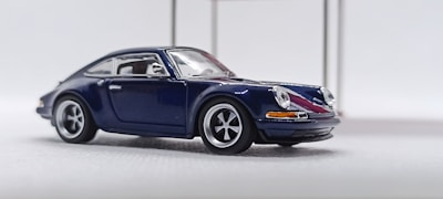 A blue sports car on a white background.