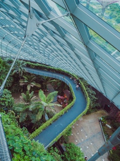 A glass greenhouse with a winding pathway.