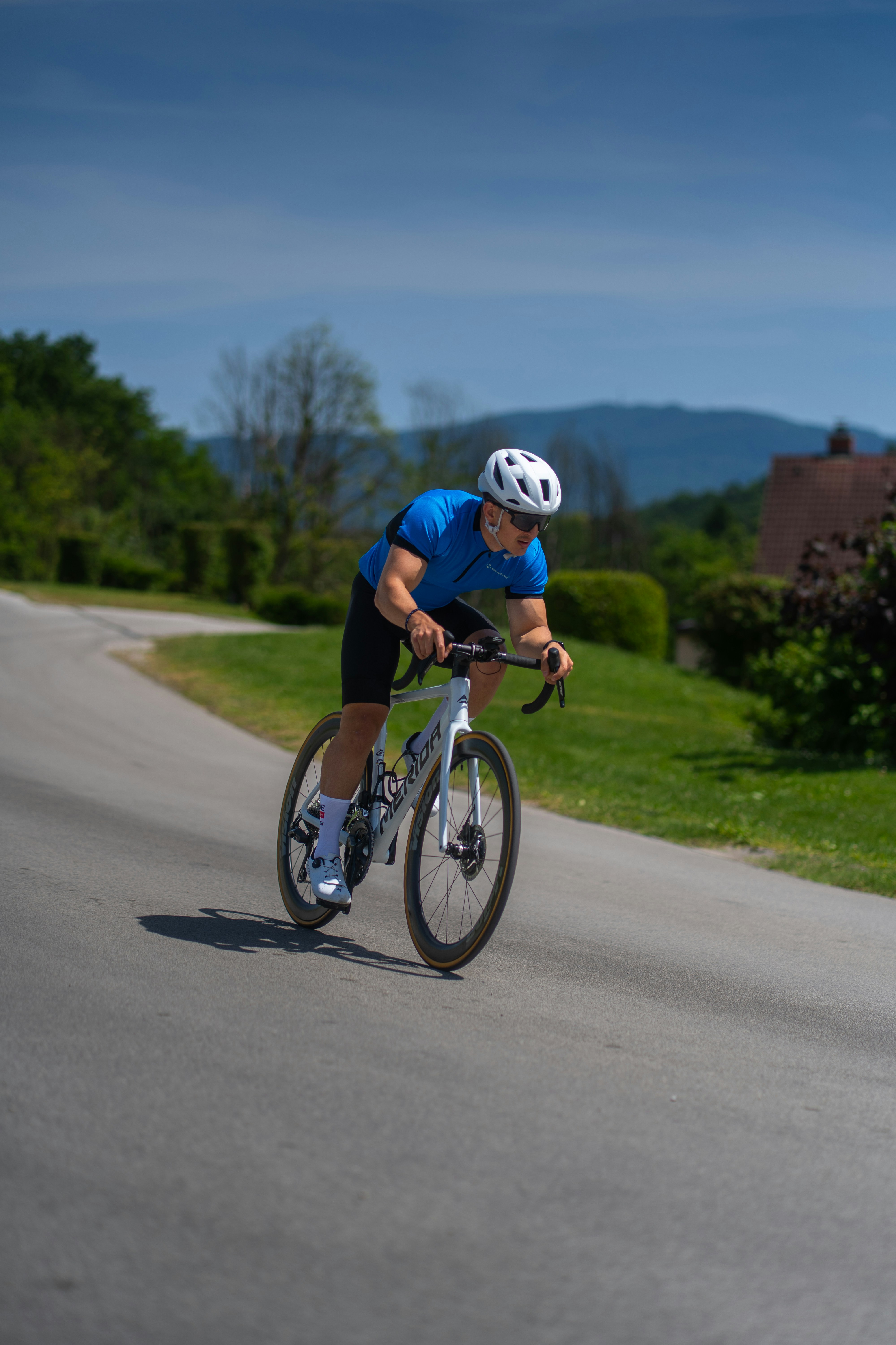 Cyclist rides a bike on a winding road.