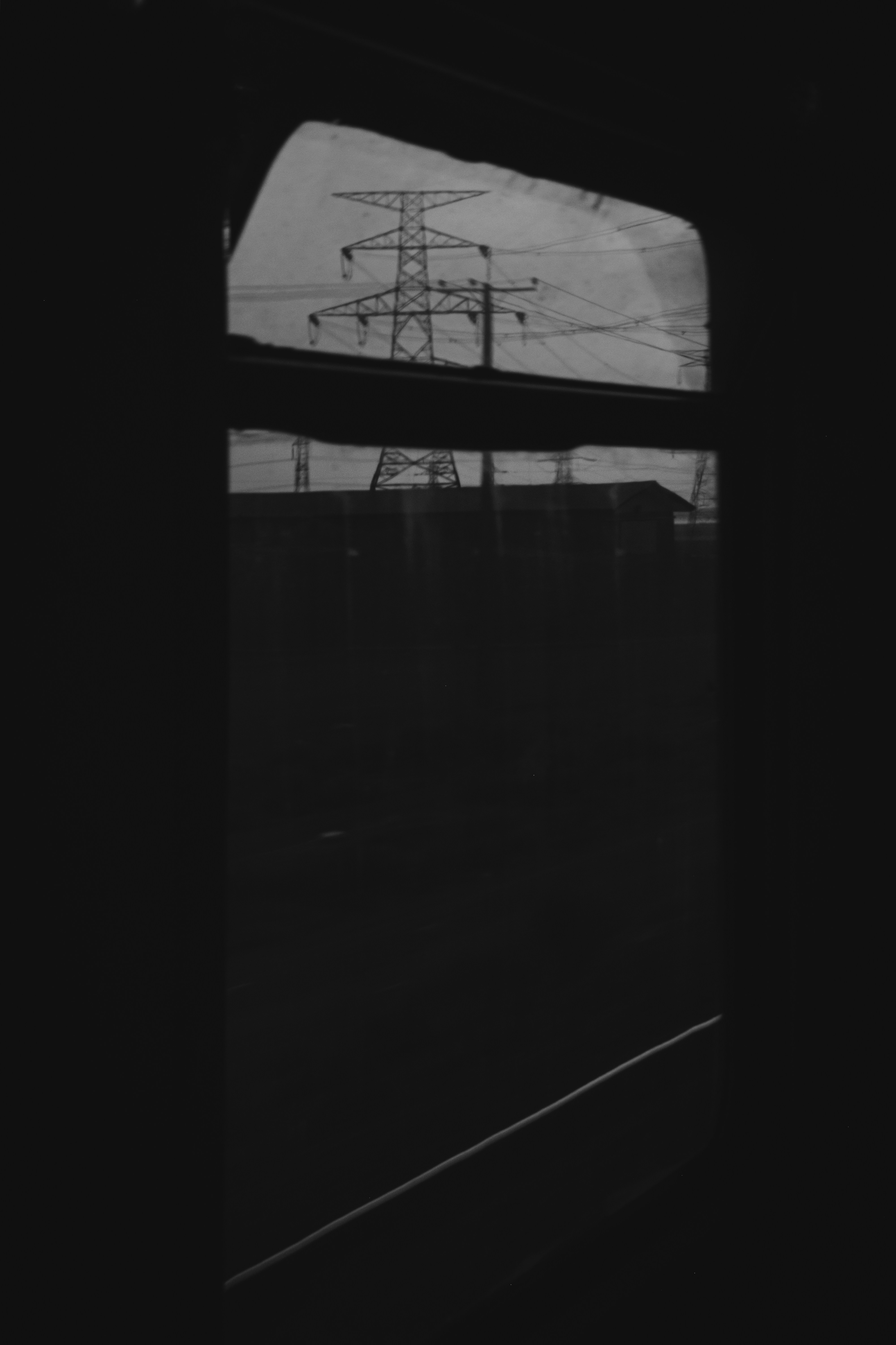 Power lines seen through a window frame.