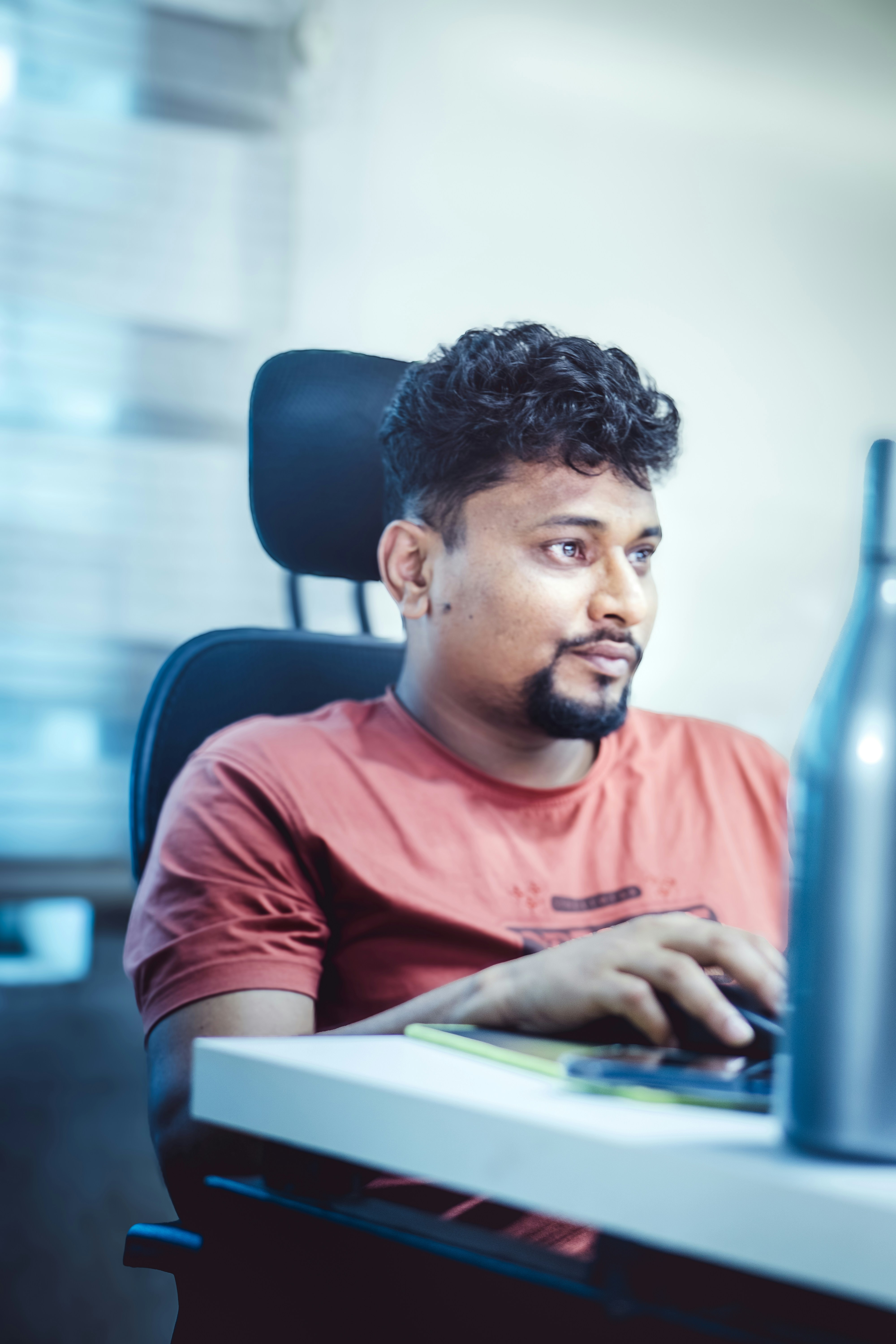 Man works on a laptop at his desk.