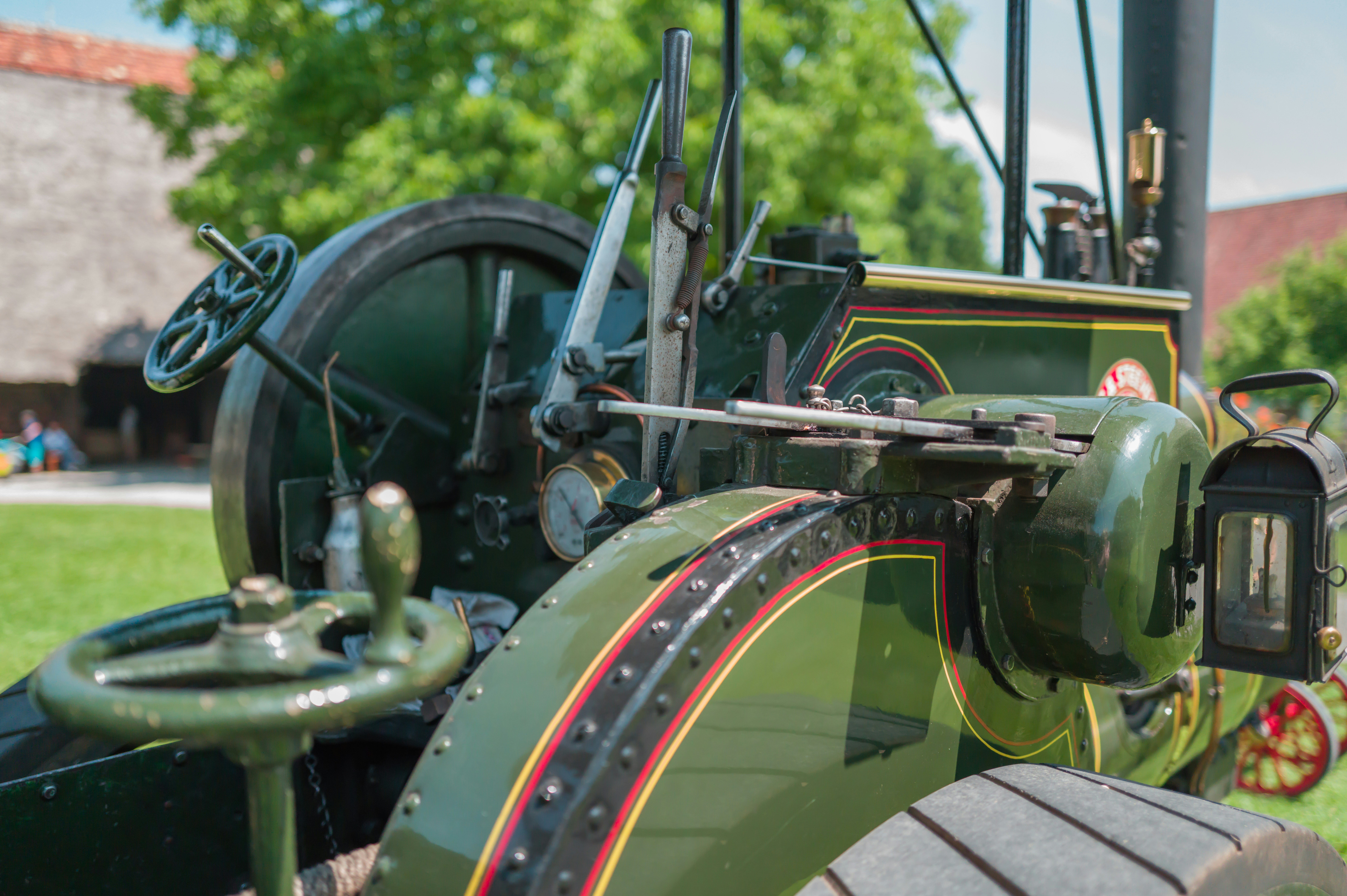 An antique steam tractor is pictured outdoors.
