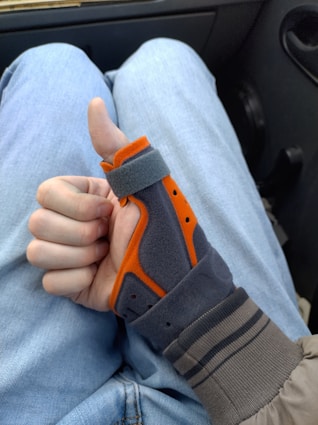 A thumb brace shows a thumbs-up gesture.