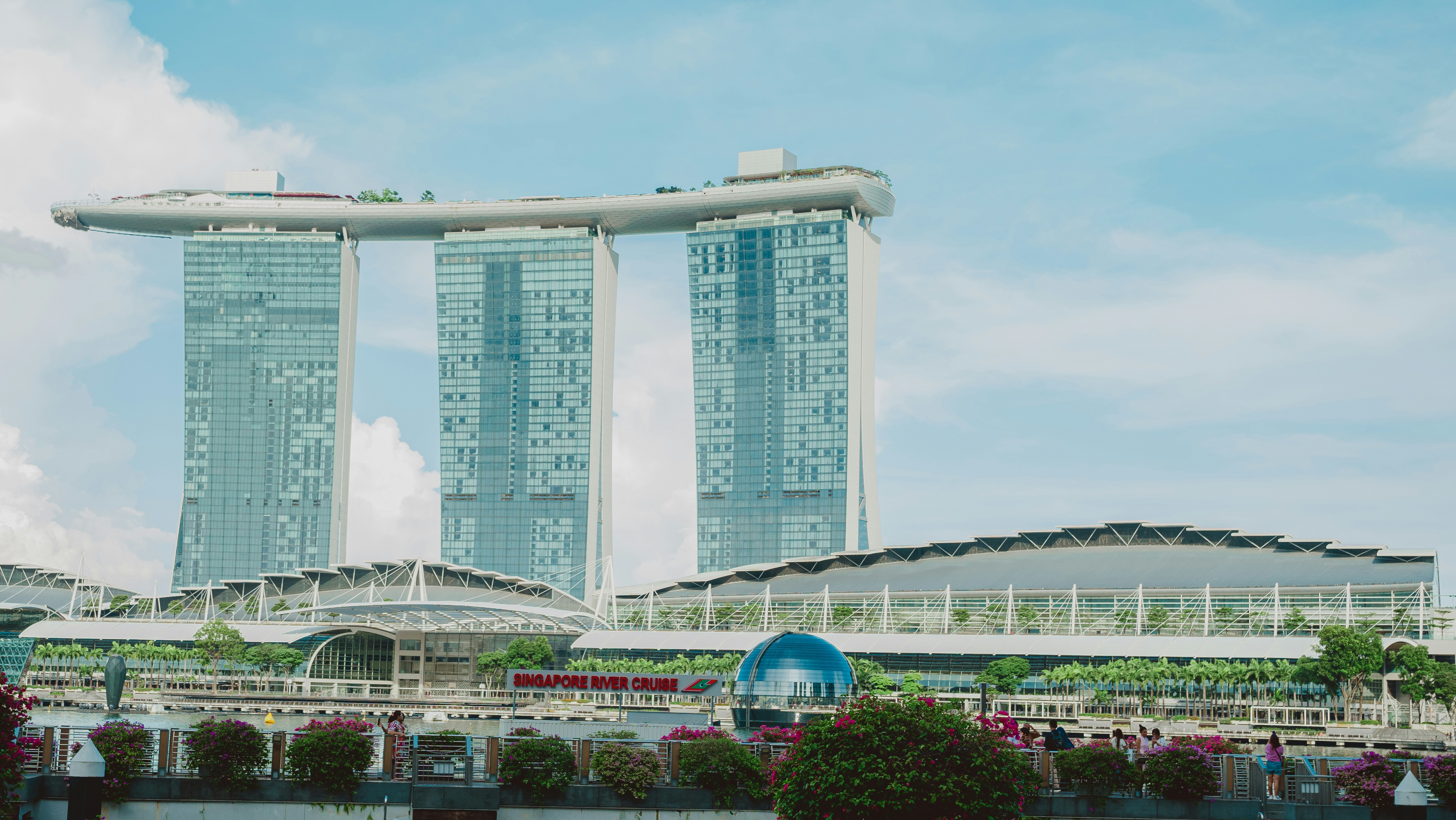 Marina bay sands towers against a blue sky.