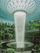 A stunning indoor waterfall at an airport.
