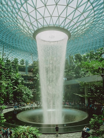 A stunning indoor waterfall at an airport.