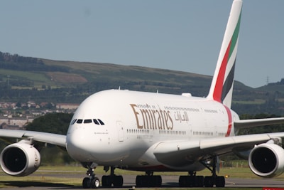 An emirates airplane is on the ground.