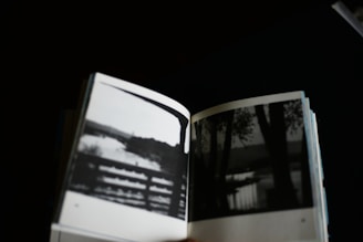 Open book displays black and white nature photos.