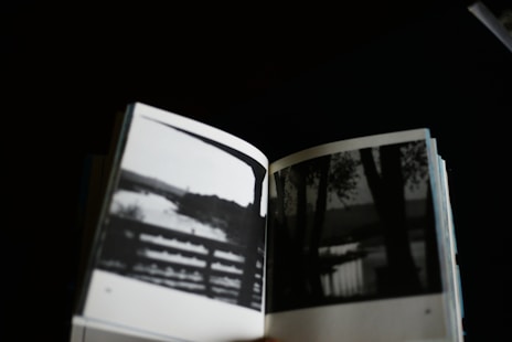 Open book displays black and white nature photos.