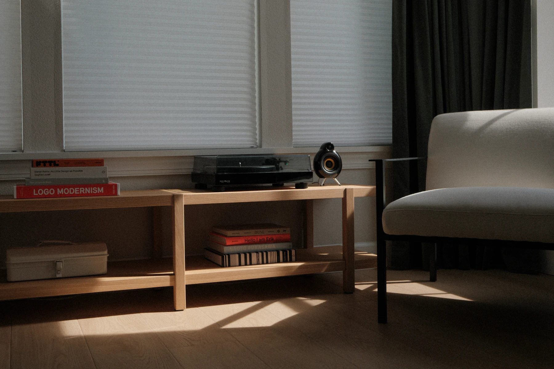 Sunlit living room corner with a record player, speaker and chair