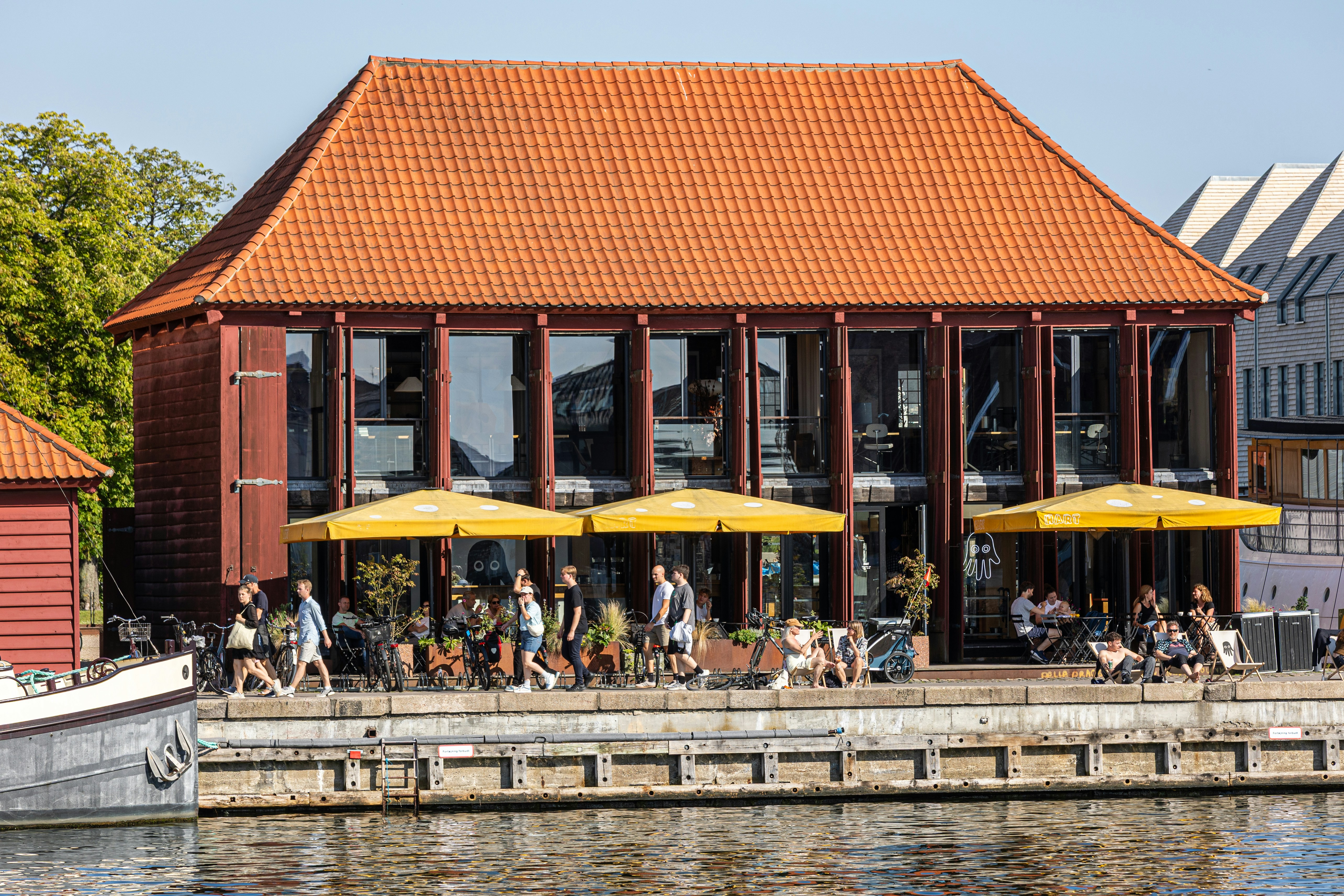 People relax and enjoy a sunny day at a cafe.
