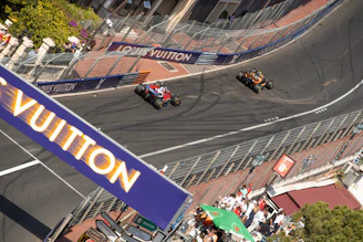 Formula 1 race cars speed around a corner