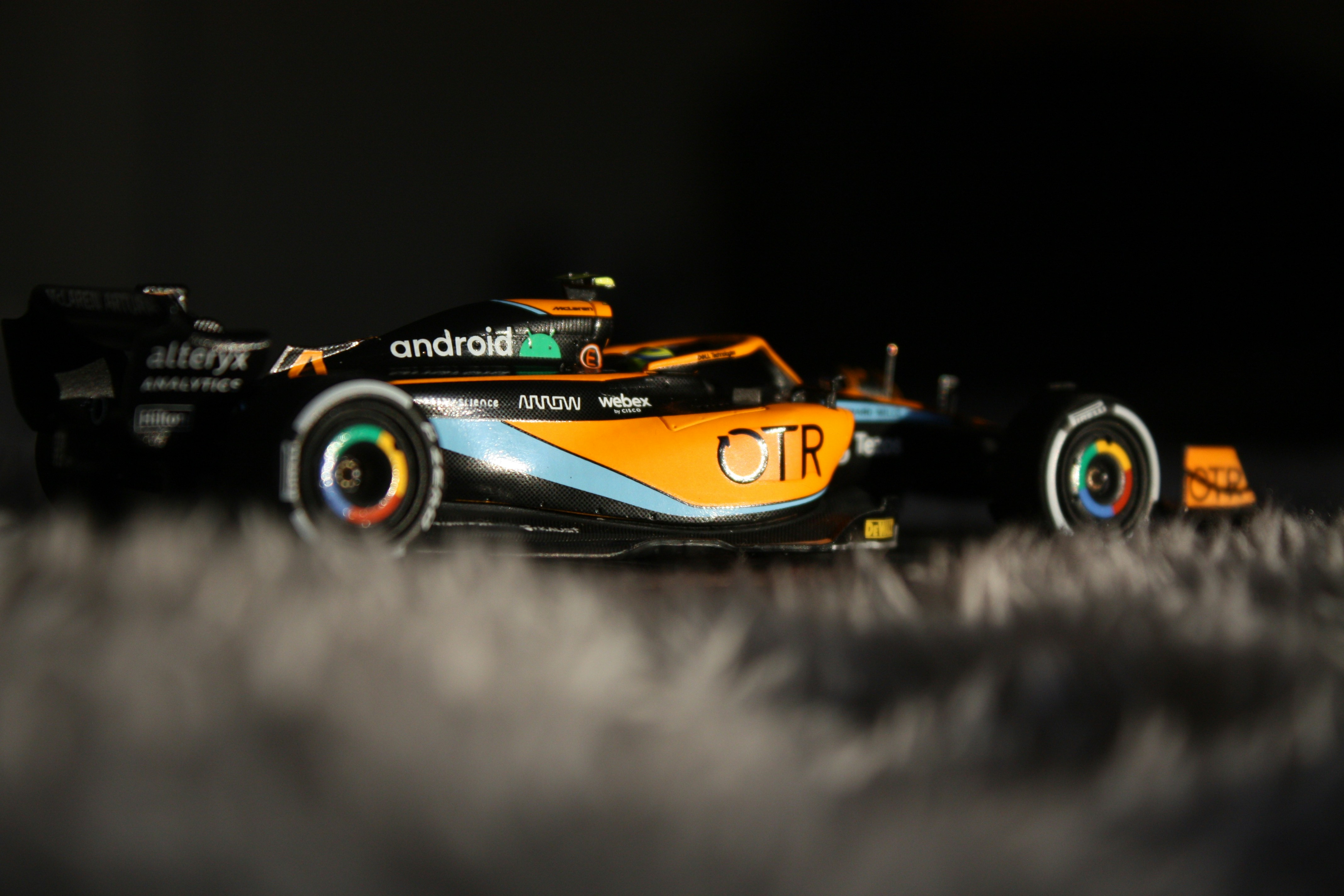 A mclaren formula 1 car speeds on a track.