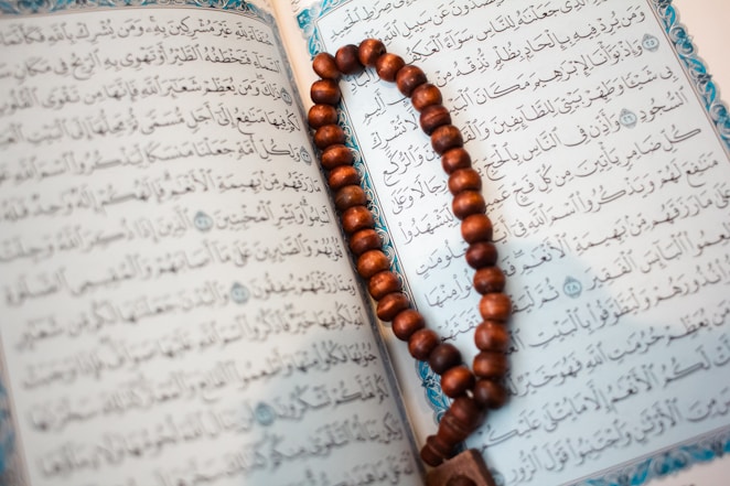 The quran and a prayer beads sit together.