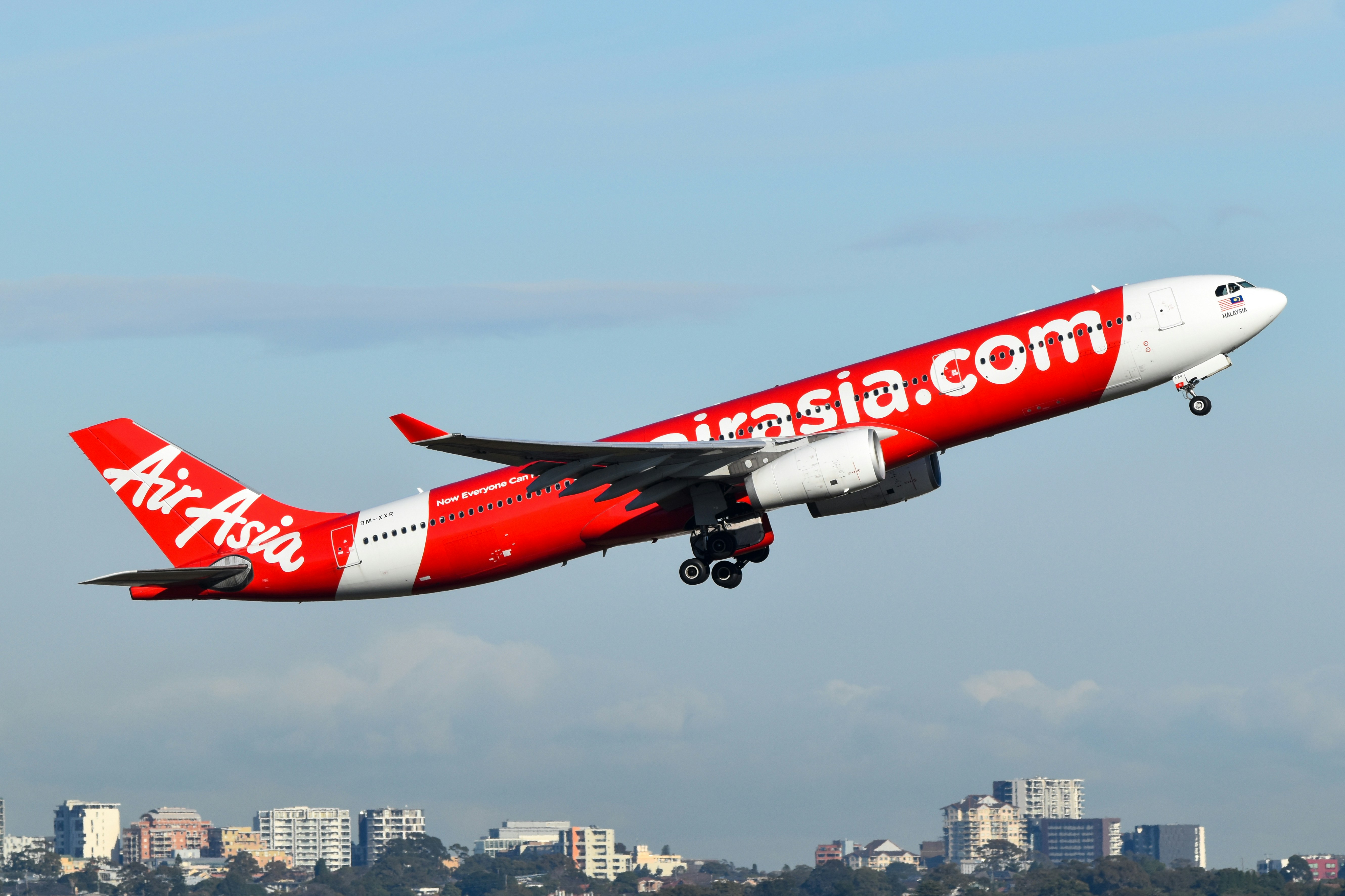 An airasia airplane is taking off.