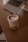 Iced coffee rests on a desk next to a laptop.