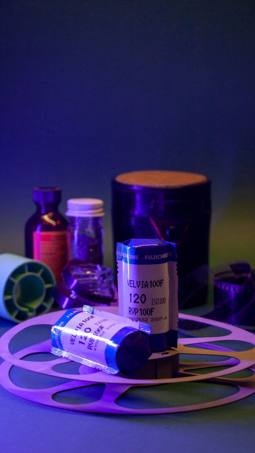 Film rolls and darkroom supplies are displayed.