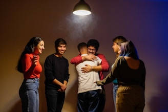 Friends embrace each other in a warm hug.