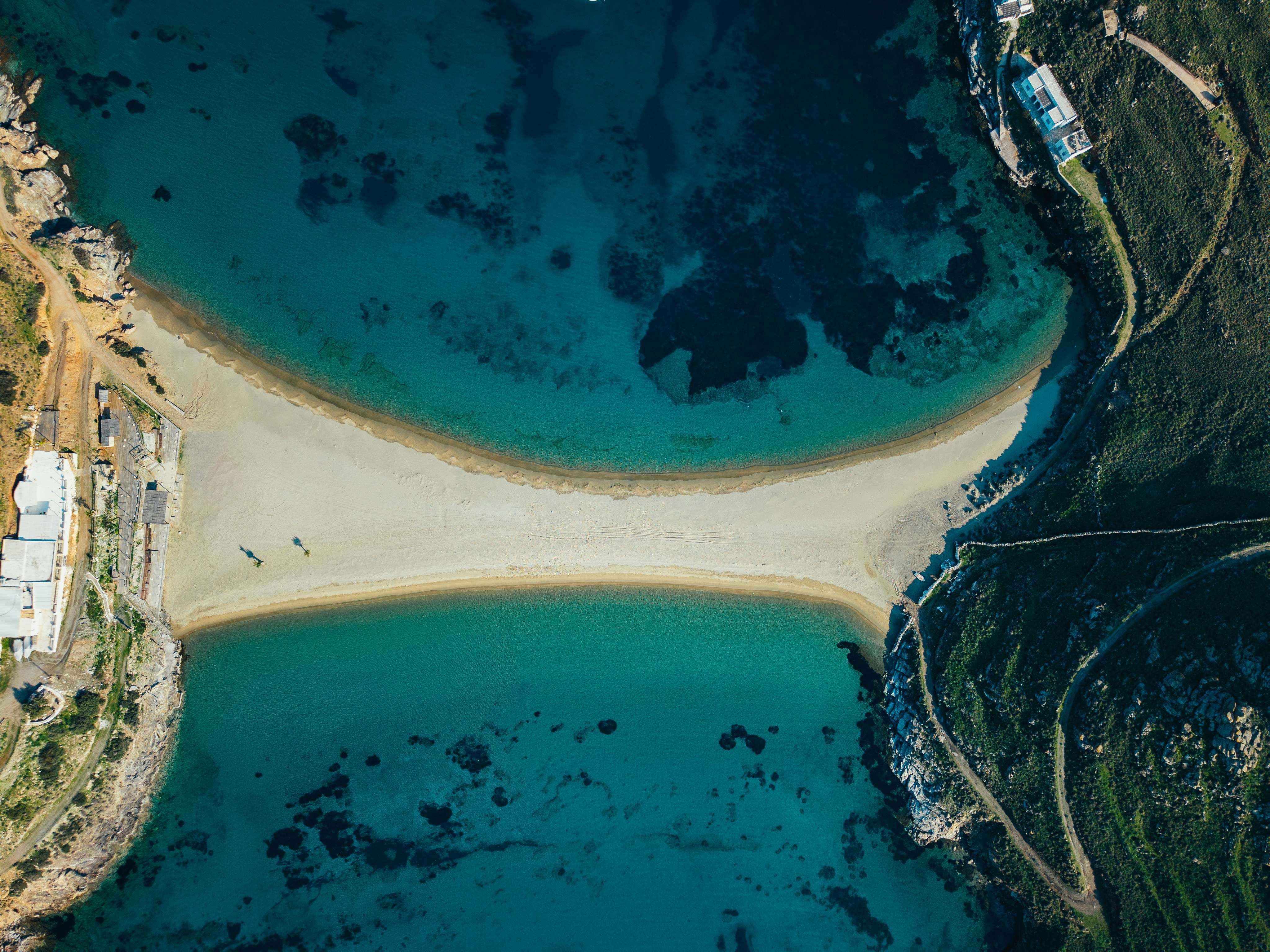 A beautiful beach connects two bodies of water.