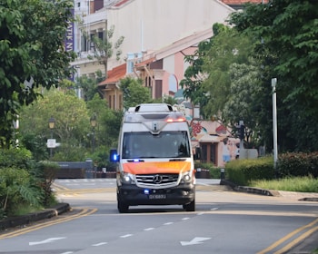 An ambulance is driving down the street.