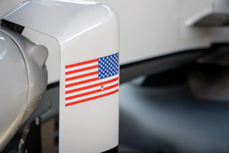 An american flag sticker is on a white surface.