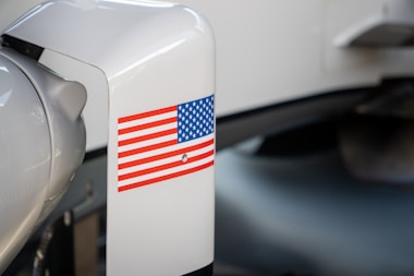 An american flag sticker is on a white surface.