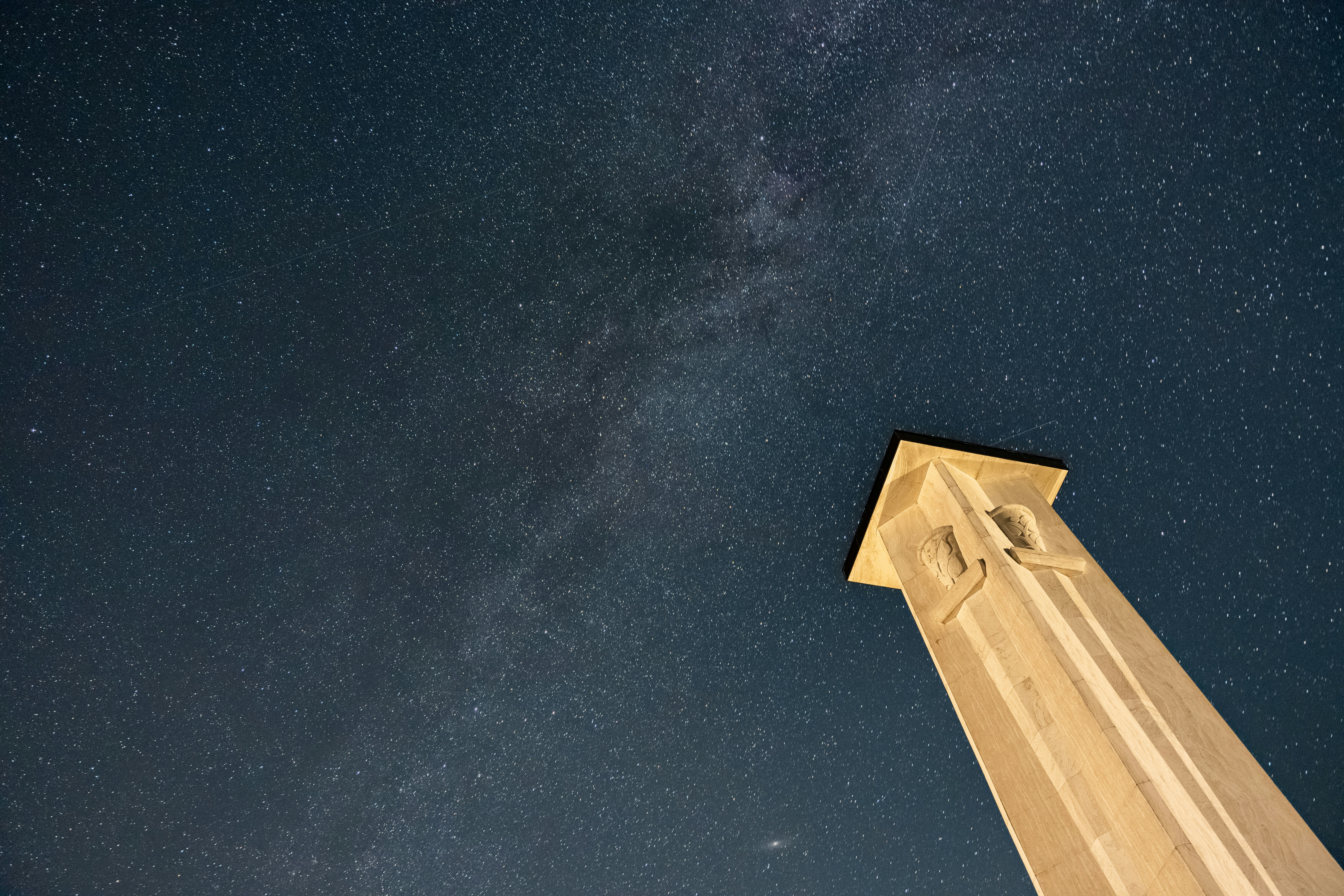A tower reaches toward the starry night sky.